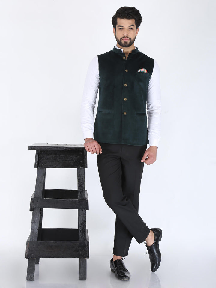 Model wearing Dark Green Velvet Partywear Nehru Jacket on white shirt and black trouser