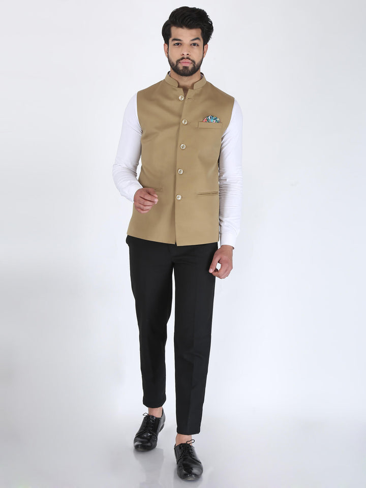 Model wearing Beige Nehru Jacket along with white shirt, black trouser, and black formal shoes